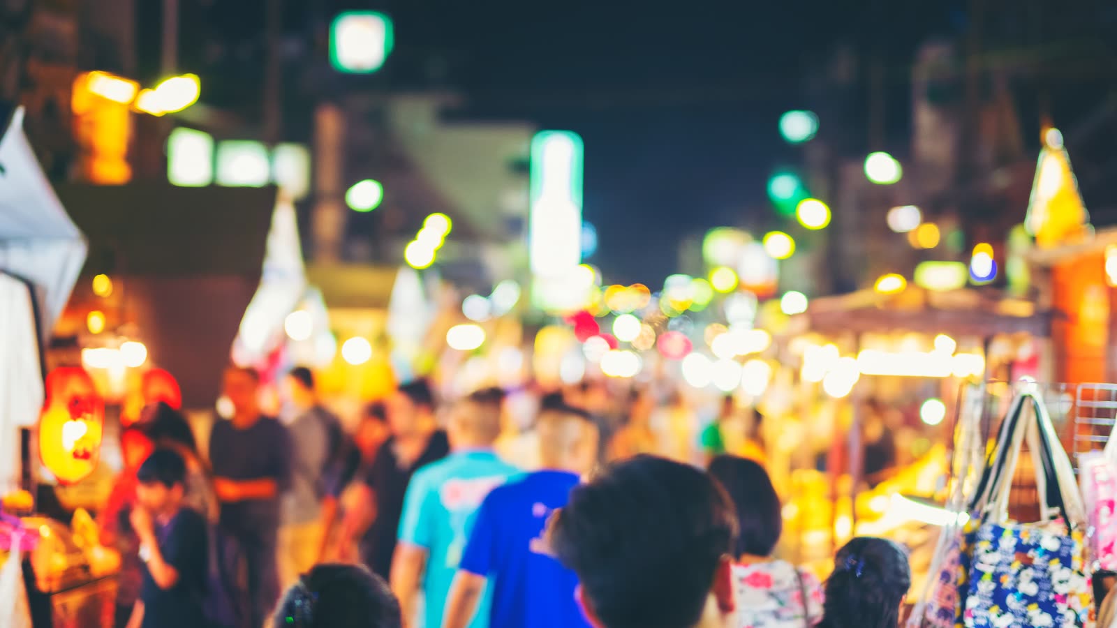 A night market crowd under strings of lights